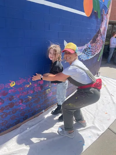 Mesa View Elementary mural — student handprints, orange spectrum
