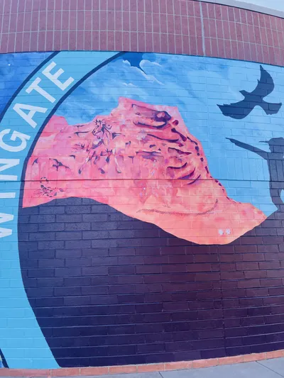 Wingate Elementary mural — Colorado National Monument–style rock panel with petroglyphs, WINGATE arc, and silhouettes